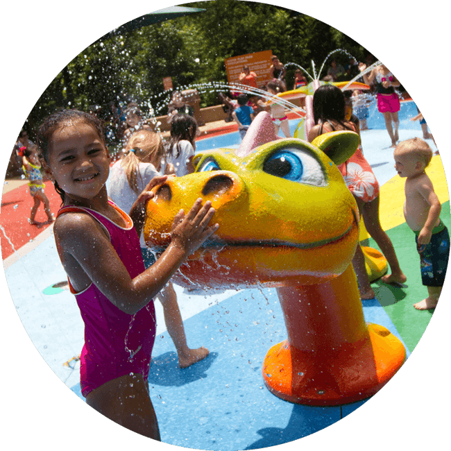 Child playing on aquatic playground with Fun Forms™ splash pad equipment